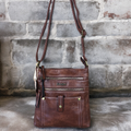 This BROWN PU Leather Cotton Road Sling Bag features Metal Zips, Adjustable Strap, Single Zip Compartment, and Twin Front Zip Compartments. It also includes a Clip Pocket and Back Zip Compartment for added convenience.