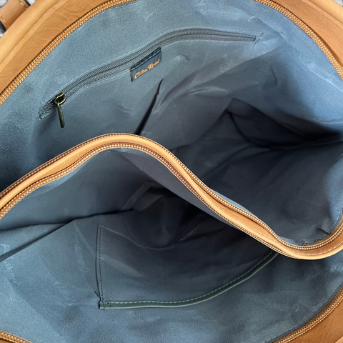 Cotton Road Handbag in khaki PU leather, showing spacious blue-grey lined compartments and interior zip pocket