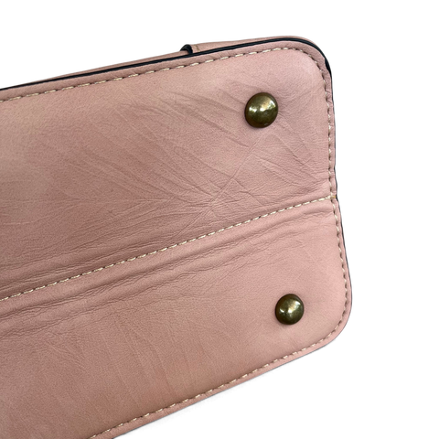 Cotton Road Handbag in dusty pink PU leather, showing stitched panels and antique-look metal feet.