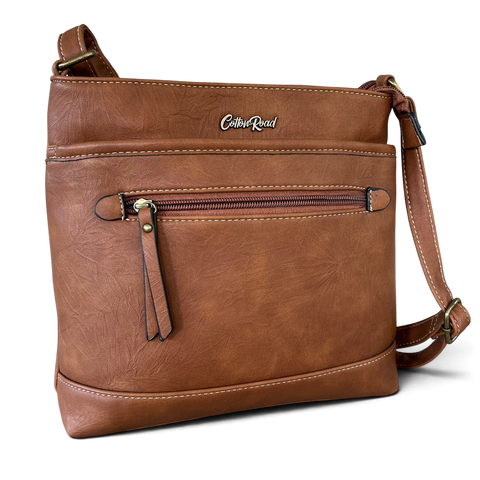 Cotton Road Sling Bag in brown PU leather with contrast stitching, front zip pocket and adjustable crossbody strap