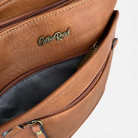 Cotton Road Sling Bag in warm brown PU leather with contrast stitching, zip compartments and branded interior.