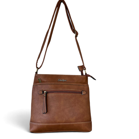 Cotton Road Sling Bag in brown PU leather, featuring contrast stitching, front zip pocket and adjustable strap