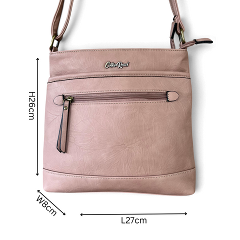 Cotton Road Sling Bag in muted pink textured PU leather, featuring contrast stitching and multiple zip compartments