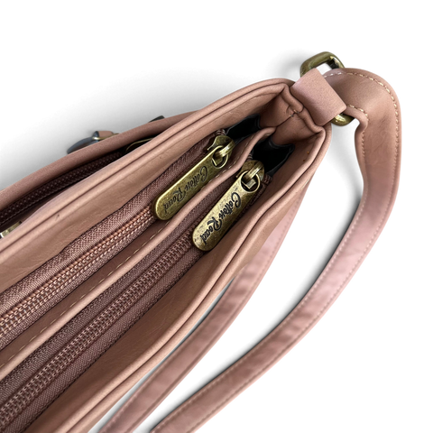 Cotton Road Sling Bag in blush pink PU leather with multiple brown zip compartments and an adjustable strap