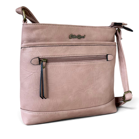 Cotton Road Sling Bag in muted pink PU leather, featuring a front zip pocket, branding and adjustable strap