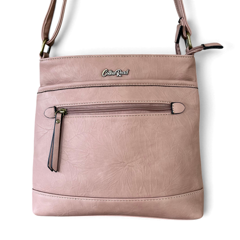Cotton Road Sling Bag in muted pink PU leather with floral embossed texture, contrast stitching and front zip pocket