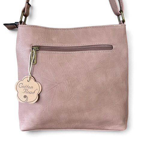 Cotton Road Sling Bag in muted pink PU leather, featuring a front zip pocket and adjustable shoulder strap.