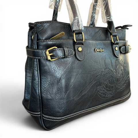 Stylish black Cotton Road handbag in PU leather with embroidered Protea design and brass hardware