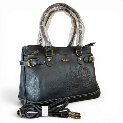 Cotton Road Handbag in black PU leather with embroidered Protea design and antique brass hardware