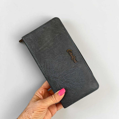 Blue Cotton Road wallet with embroidered protea design and multiple compartments for organization