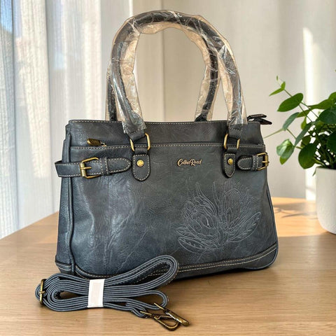 Cotton Road blue PU leather handbag with embroidered Protea design and antique brass hardware