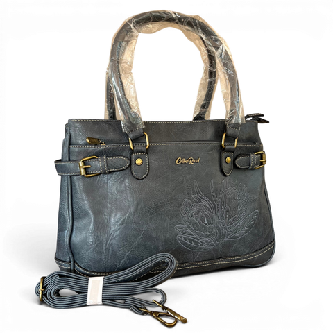 Cotton Road Handbag in blue PU leather with embroidered Protea design and brass hardware