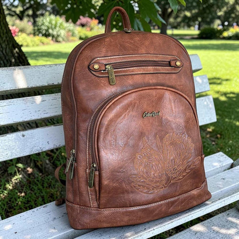 Brown PU leather Cotton Road laptop backpack with embroidered Protea design and multiple compartments