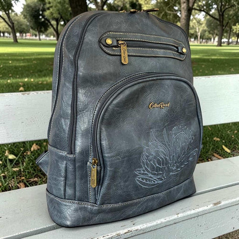 Blue Protea embroidered Cotton Road laptop bag in blue PU leather with padded laptop compartment and multiple zip pockets