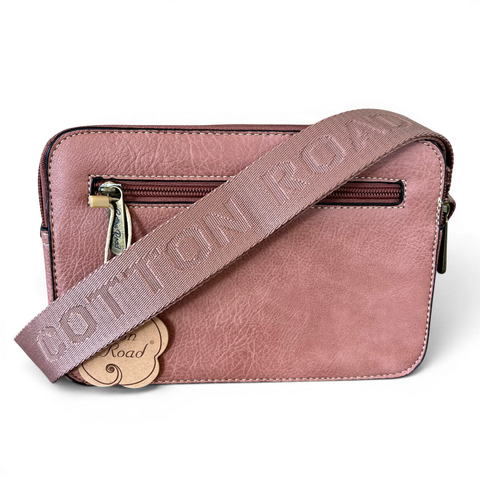 Pink Cotton Road sling bag in PU leather with floral front pocket and branded strap