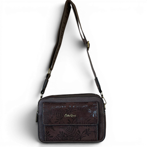 Cotton Road Sling Bag in coffee brown PU leather with floral print pocket and branded strap.