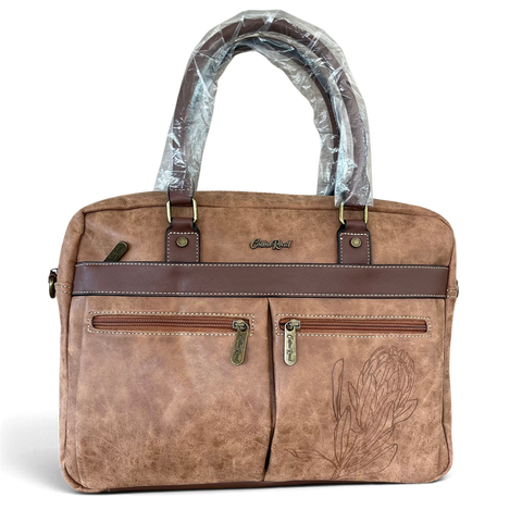 Cotton Road Laptop Bag in brown PU leather, featuring twin handles, front zip pockets and an embossed protea design