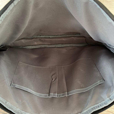 Cotton Road Laptop Bag in brown PU leather, showing a padded interior with protective laptop compartment and pocket.