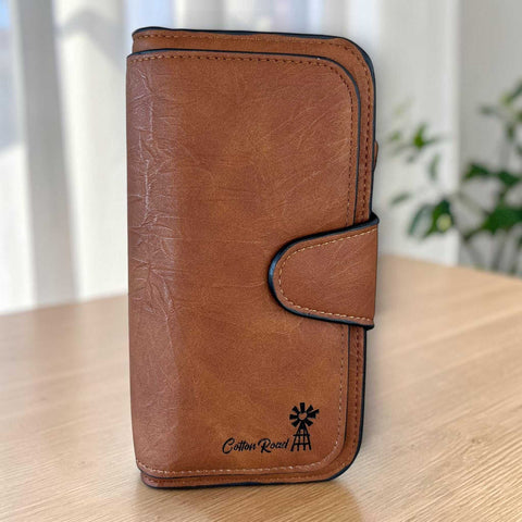 Cotton Road Wallet in warm brown textured PU leather with stitched edges, rounded corners and windmill logo detail
